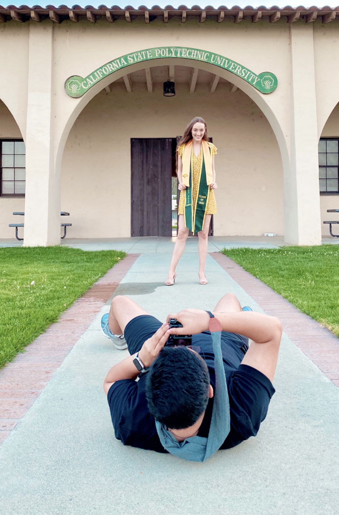 Photographer lying on the ground taking a portrait